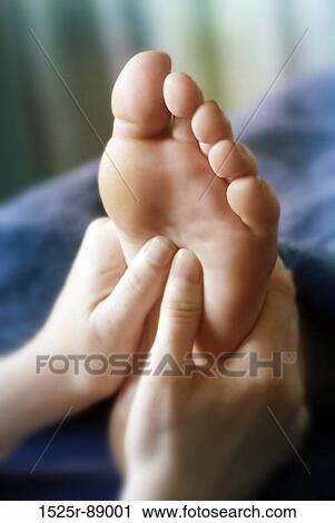 Close-up of a woman's hand massaging a person's foot View Large Photo Image Stock Image - Close-up of a woman's hand massaging a person's foot. Fotosearch