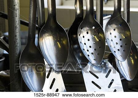 Close-up of kitchen utensils hanging in the kitchen View Large Photo Image Stock Photo - Close-up of kitchen utensils hanging in the kitchen. Fotosearch