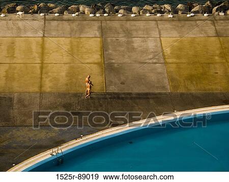High angle view of two people walking near a pool View Large Photo Image Stock Photo - High angle view of two people walking near a pool. Fotosearch