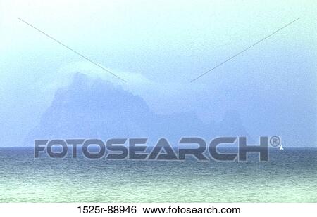 Panoramic view of the sea with a mountain in the background View Large Photo Image Stock Photograph - Panoramic view of the sea with a mountain in the background. Fotosearch