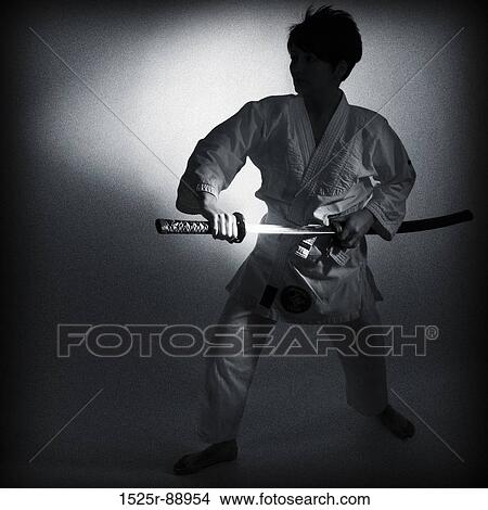 Samurai taking out a sword from a sheath View Large Photo Image Picture - Samurai taking out a sword from a sheath. Fotosearch