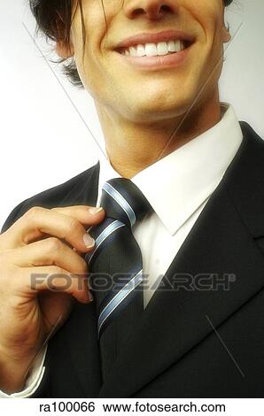 Adjusting tie View Large Photo Image Stock Photograph - Adjusting tie. Fotosearch