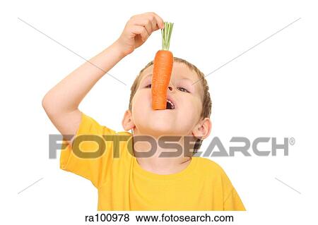 Boy eating carrot View Large Photo Image Stock Photo - Boy eating carrot. Fotosearch