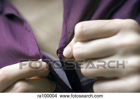 Buttoning shirt View Large Photo Image Picture - Buttoning shirt. Fotosearch