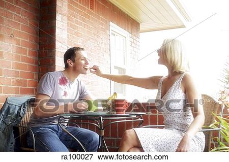 Couple eating together View Large Photo Image Stock Photo - Couple eating together. Fotosearch