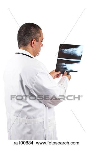 Doctor examines x ray View Large Photo Image Picture - Doctor examines x ray. Fotosearch