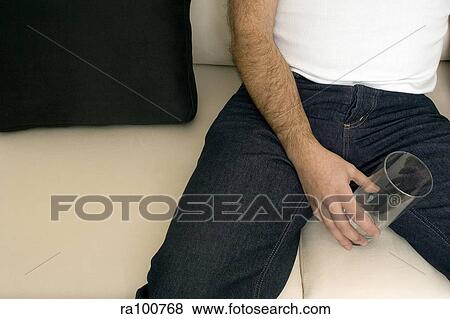 Drinking man on sofa View Large Photo Image Stock Photo - Drinking man on sofa. Fotosearch