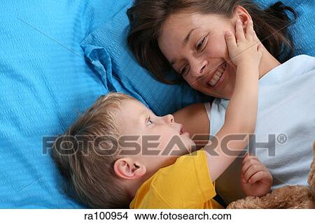 Family in bed together View Large Photo Image Picture - Family in bed together. Fotosearch