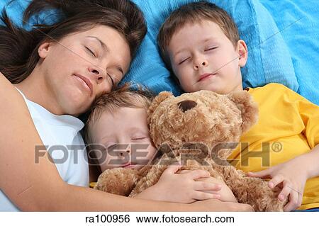 Family in bed together View Large Photo Image Stock Photograph - Family in bed together. Fotosearch