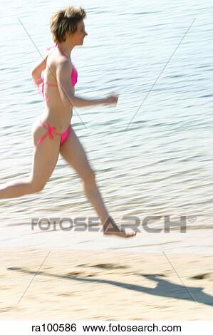 Jogging on beach View Large Photo Image Stock Photograph - Jogging on beach. Fotosearch