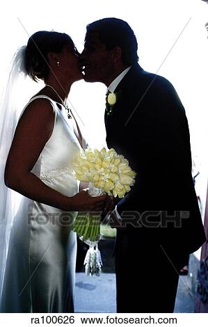 Stock Photograph - Kissing bride and groom. Fotosearch