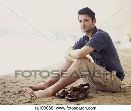 Man sitting on beach View Large Photo Image Stock Photo - Man sitting on beach. Fotosearch