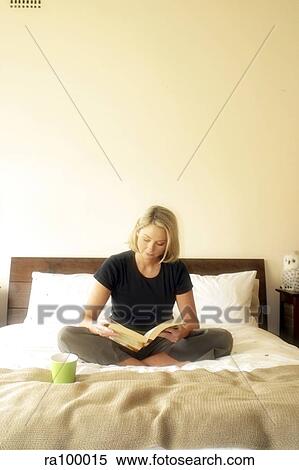 Stock Photography - On bed with a book. Fotosearch