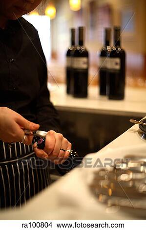 Opening wine View Large Photo Image Picture - Opening wine. Fotosearch