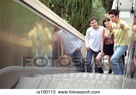 Stock Image - Teens on escalator. Fotosearch