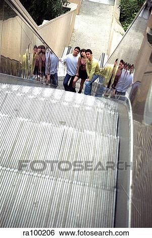Teens on escalator View Large Photo Image Stock Photograph - Teens on escalator. Fotosearch