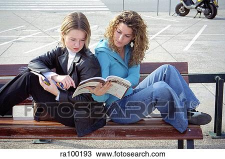 Two students on a bench View Large Photo Image Stock Image - Two students on a bench. Fotosearch