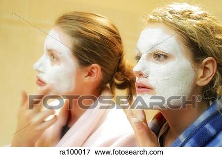 Two women with face masks View Large Photo Image Stock Photo - Two women with face masks. Fotosearch