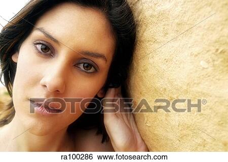 Woman against a wall View Large Photo Image Stock Photograph - Woman against a wall. Fotosearch