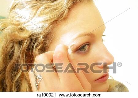 Woman applying eye make up View Large Photo Image Stock Image - Woman applying eye make up. Fotosearch