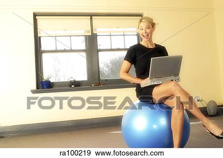Woman on ball with laptop View Large Photo Image Stock Photo - Woman on ball with laptop. Fotosearch