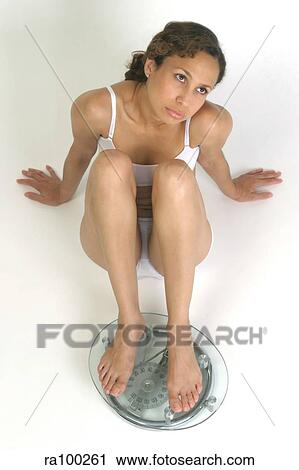 Woman on scales View Large Photo Image Stock Image - Woman on scales. Fotosearch