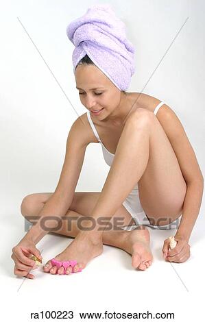 Stock Image - Woman painting nails. Fotosearch