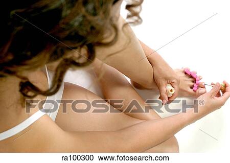 Stock Image - Woman painting nails. Fotosearch