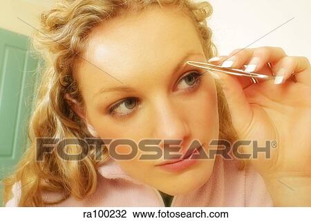 Woman plucking eyebrow View Large Photo Image Stock Image - Woman plucking eyebrow. Fotosearch