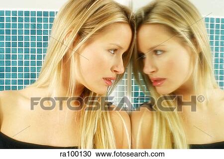 Stock Image - Woman's reflection in mirror. Fotosearch