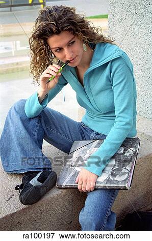 Young woman sitting View Large Photo Image Stock Photo - Young woman sitting. Fotosearch