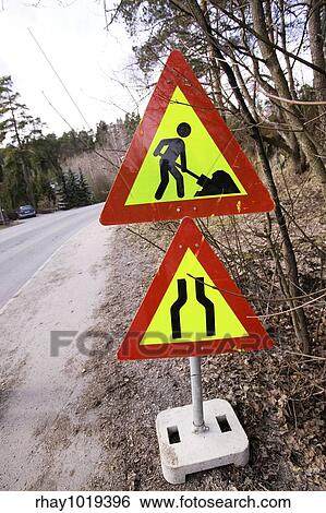 A construction sign on the side of the road. View Large Photo Image Stock Photograph - A construction sign on the side of the road.. Fotosearch