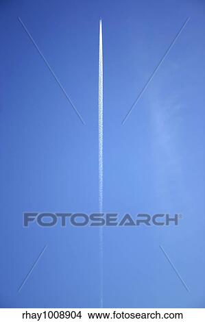 A jet flying overhead with jet trails. View Large Photo Image Picture - A jet flying overhead with jet trails.. Fotosearch