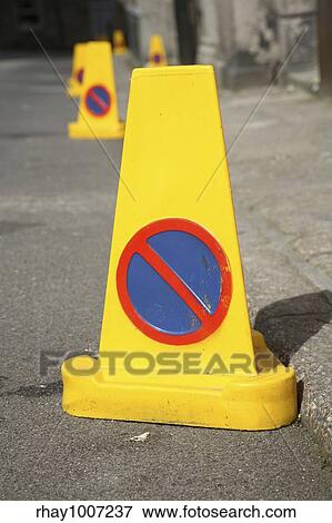 A line of yellow no parking cones in the road. View Large Photo Image Stock Photo - A line of yellow no parking cones in the road.. Fotosearch