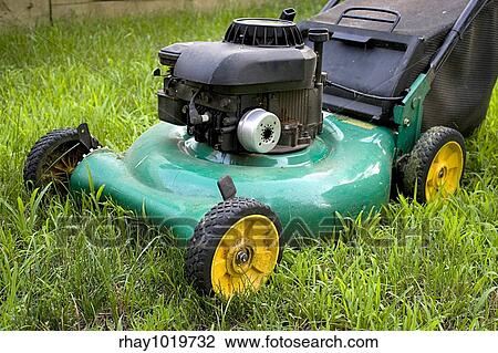 A modern lawn mower cutting through the grass. View Large Photo Image Stock Image - A modern lawn mower cutting through the grass.. Fotosearch