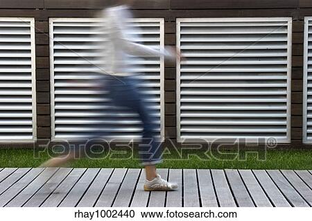 Stock Image - A motion blur abstract of a person walking in a hurry. Fotosearch