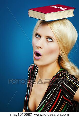 a stereotypical retarded blond model using a book over her head to train a correct posture on catwalk View Large Photo Image Stock Photo - a stereotypical retarded blond model using a book over her head to train a correct posture on catwalk. Fotosearch