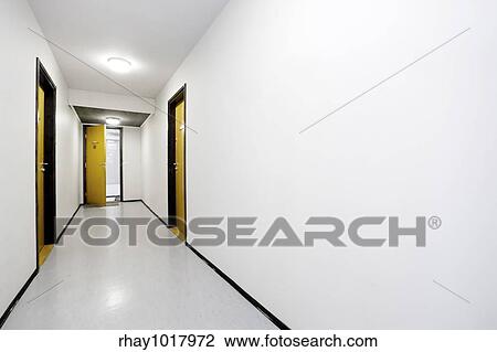 A sterile empty hallway with a single door open View Large Photo Image Stock Image - A sterile empty hallway with a single door open. Fotosearch
