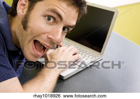 Stock Photograph - A wild man at the computer. Fotosearch