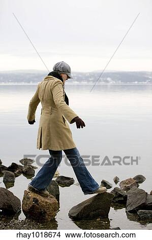A woman standing near the ocean View Large Photo Image Picture - A woman standing near the ocean. Fotosearch
