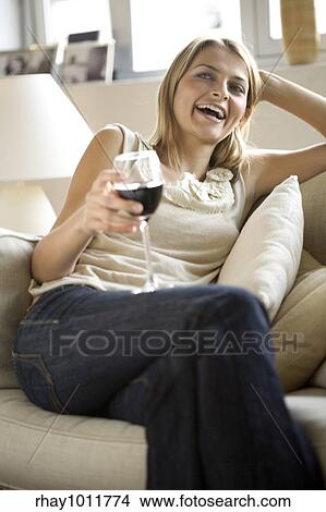 Picture - attractive blond woman working from home. Fotosearch