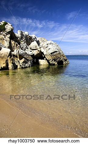 Beautiful blue beach with rocks and turquoise water View Large Photo Image Stock Image - Beautiful blue beach with rocks and turquoise water. Fotosearch