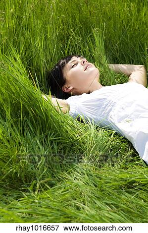 beautiful girl lying down of grass. Copy space View Large Photo Image Stock Photo - beautiful girl lying down of grass. Copy space. Fotosearch