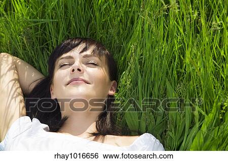 beautiful girl lying down of grass. Copy space View Large Photo Image Stock Photograph - beautiful girl lying down of grass. Copy space. Fotosearch