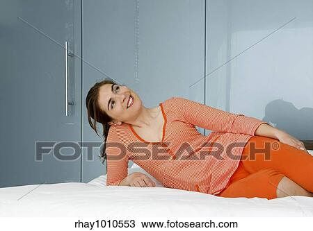 Beautiful woman in pajama on bed and relaxing View Large Photo Image Stock Image - Beautiful woman in pajama on bed and relaxing. Fotosearch