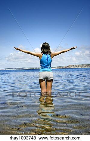 Beautiful woman in the water feeling the breeze View Large Photo Image Stock Photo - Beautiful woman in the water feeling the breeze. Fotosearch