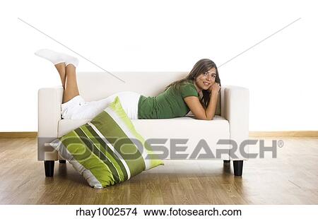 Beautiful woman relaxing on the couch at home View Large Photo Image Picture - Beautiful woman relaxing on the couch at home. Fotosearch