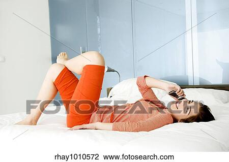Beutiful happy woman in pajama talking at mobile phone View Large Photo Image Stock Image - Beutiful happy woman in pajama talking at mobile phone. Fotosearch
