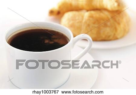 Stock Photo - Breaksfast of black coffee and fresh croissants. Fotosearch