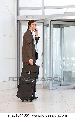 Stock Image - businessman entering building. Fotosearch